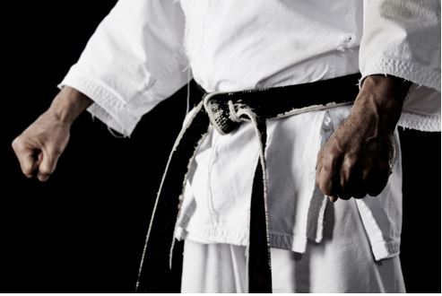 Photo of Close-up of a karate uniform with a black belt