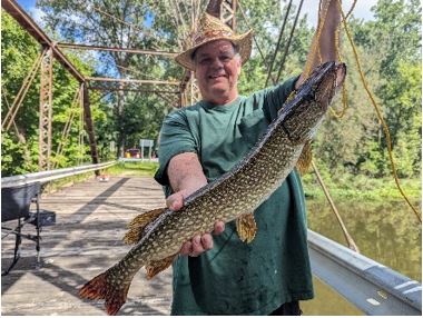 Photo of Dan Hyatt holding a caught fish