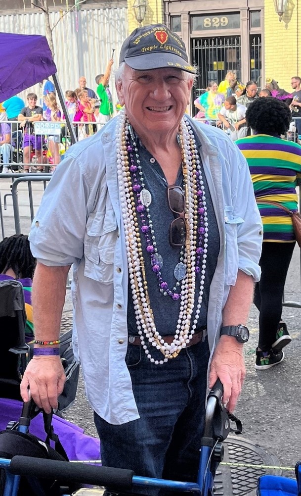 photo of David Devaney standing outside at a Mardi Gras parade
