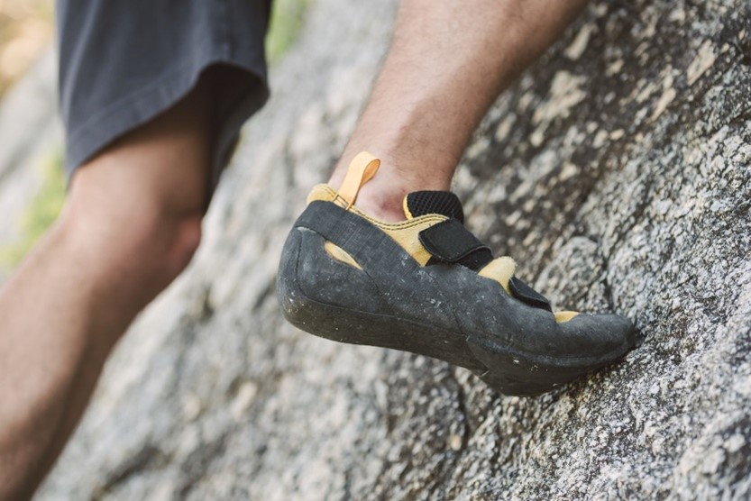 Photo of a foot of a rock climber in action
