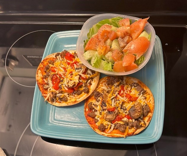 Photo of Vickie's homemade pizza and salad.