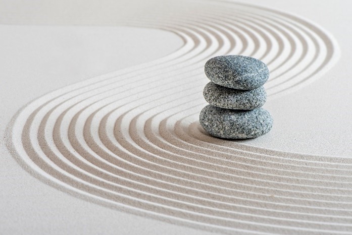 Photo of stacked stones in raked sand