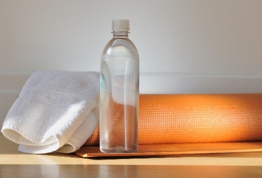 Photo of water bottle with towel and yoga mat