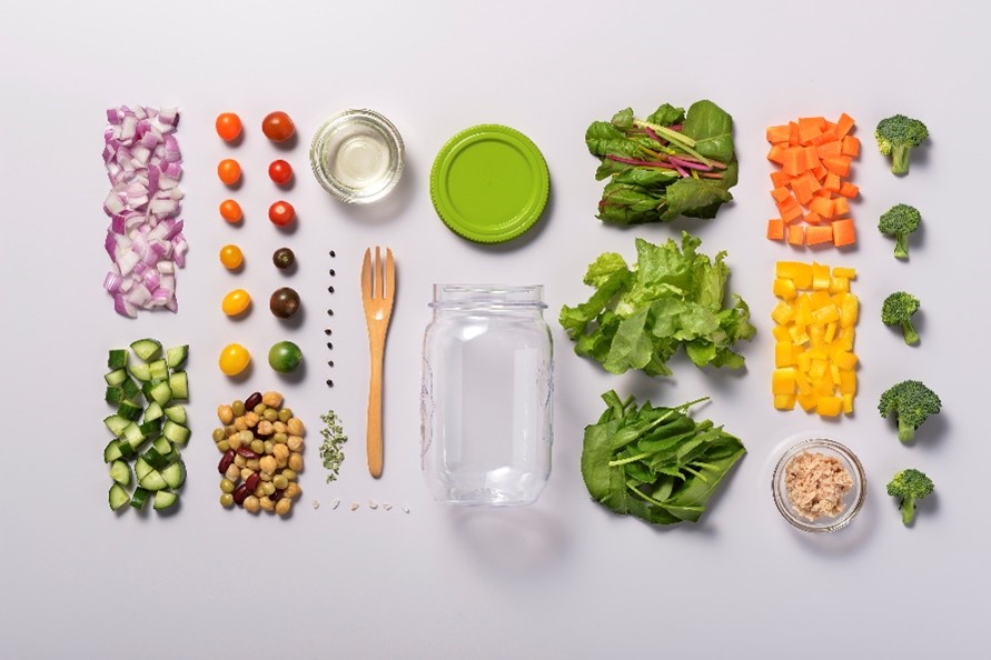 Photo of Colored vegetables lined up with fork and pot