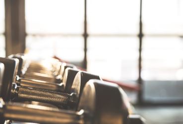 Photo of a row of dumbbells next to window